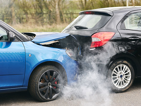 A black car having been hit by a blue car in a rear end collision