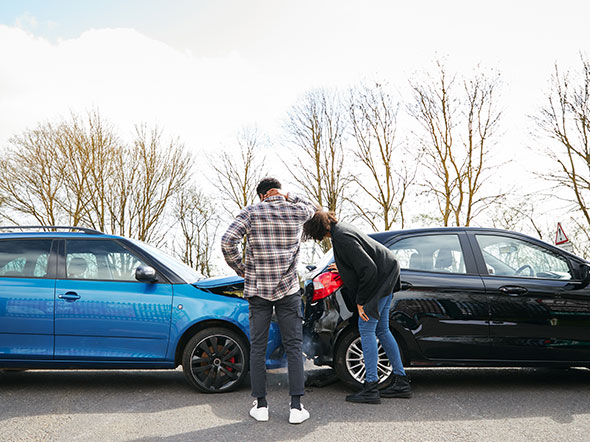 Two people arguing over fault in a rear-end collision