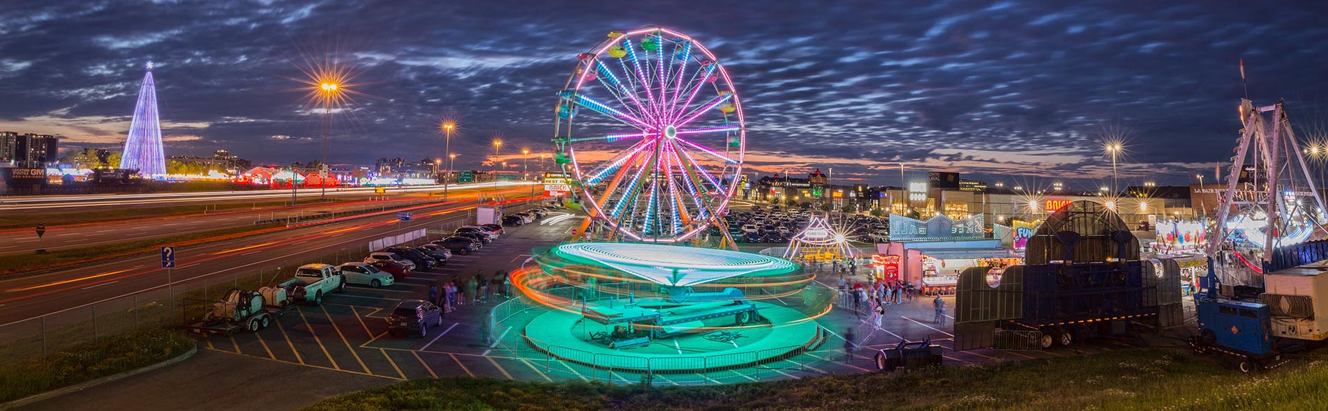 An amusement park viewed from high up, lit up under a night sky