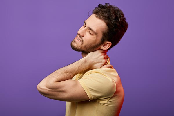 attractive man has pain in neck.how do you relieve spasms in neck