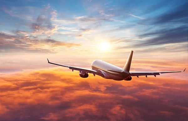 Passengers commercial airplane flying above clouds