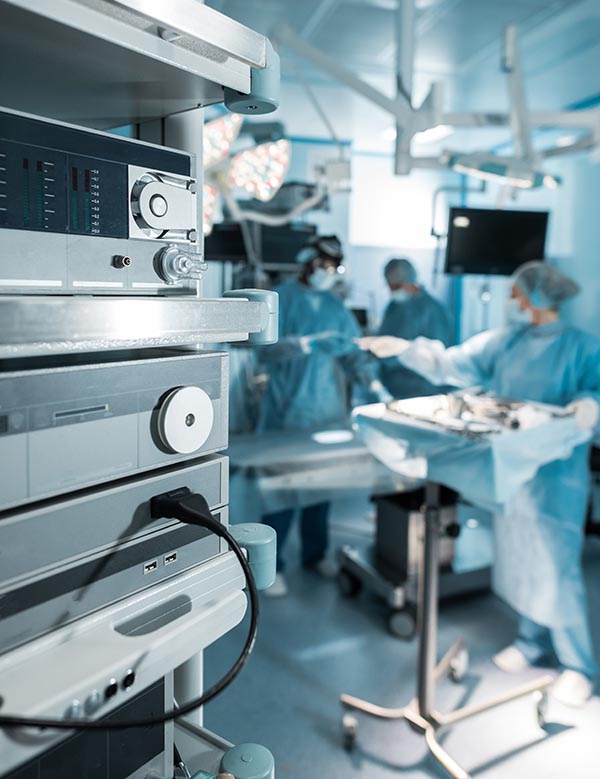 four surgeons in operating room in hospital