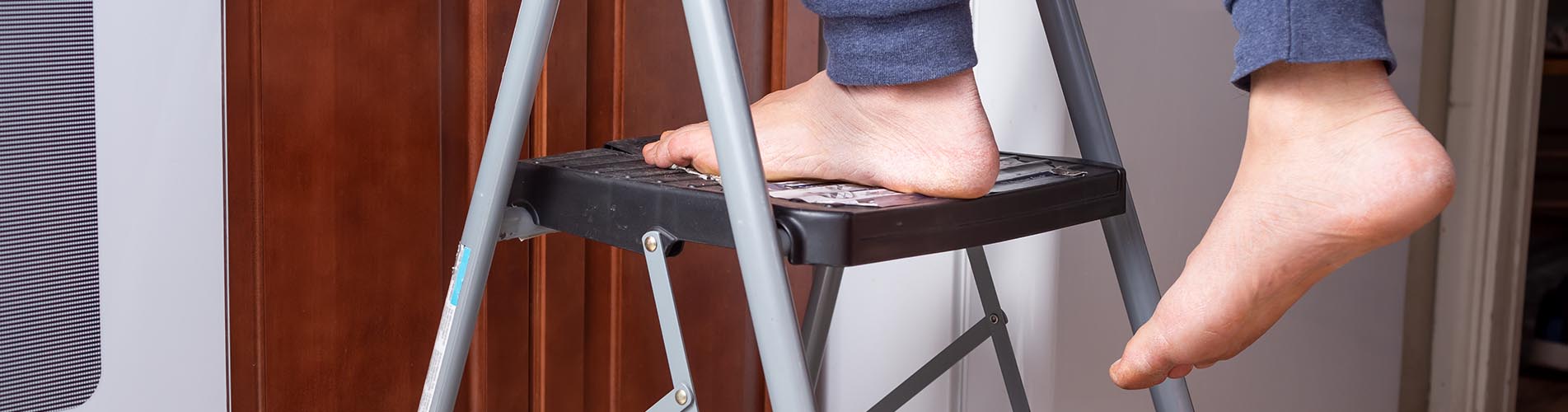 A view of a person and their feet on a two level step ladder in