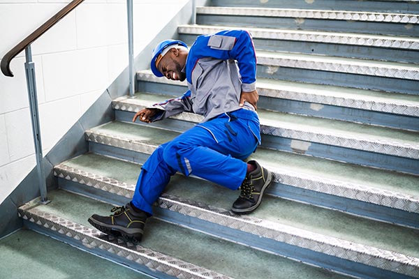 Worker Man Lying On Staircase After Slip And Fall Accident