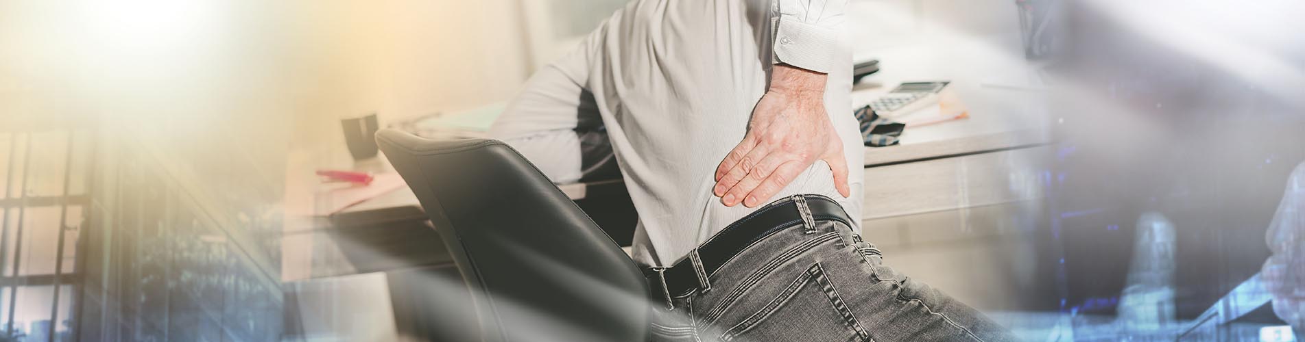 Businessman suffering from back pain in office, light effect; multiple exposure